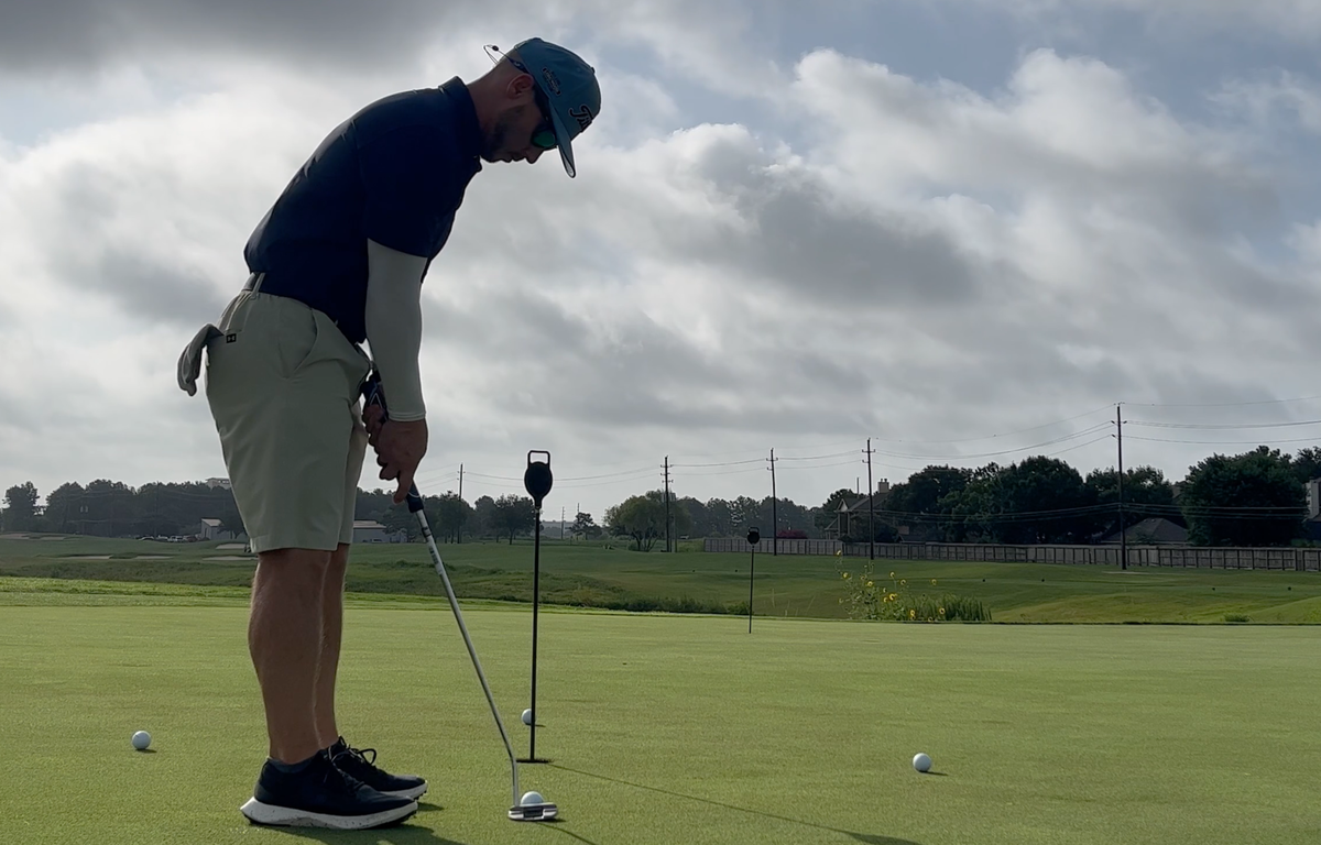 Golfer Geek setting up to putt