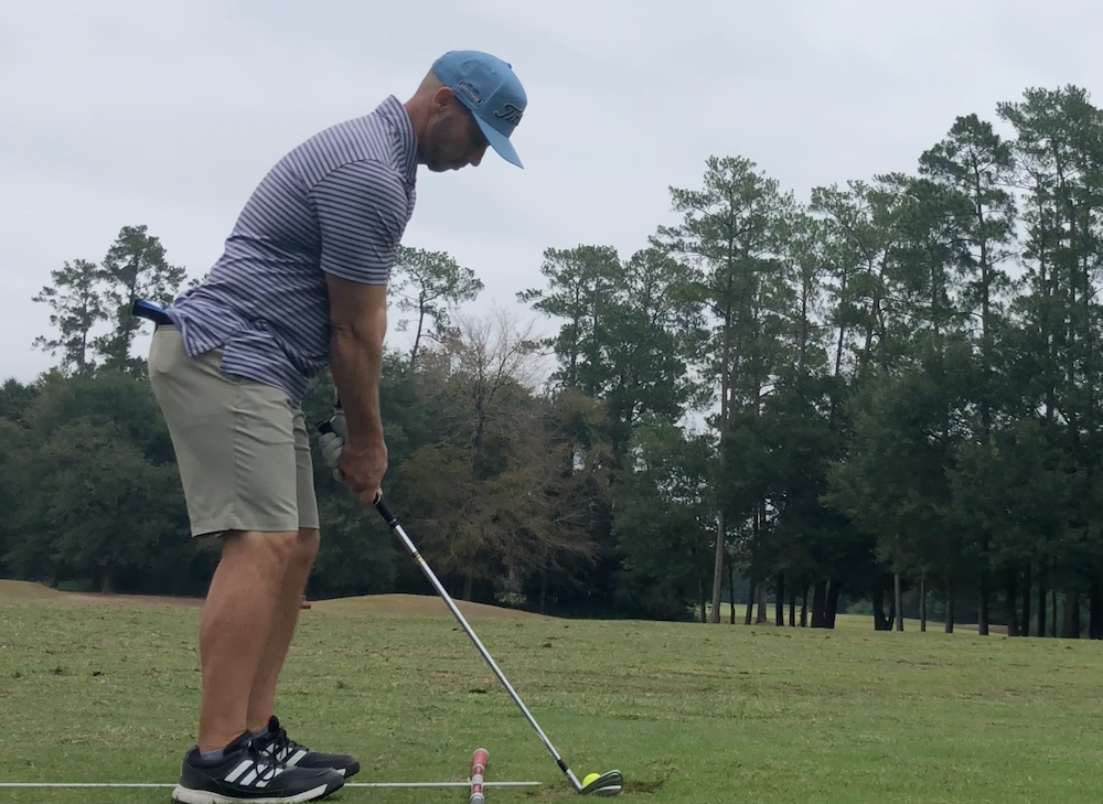 Golfer Geek setting up to a pitching wedge